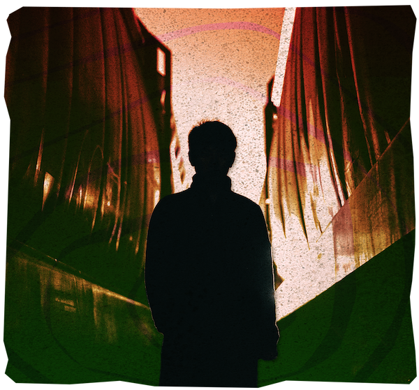 Silhouette of a person standing in front of burning curtains